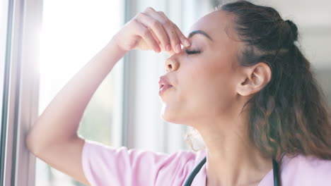 Nurse,-thinking-or-stress-headache-by-window