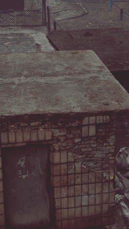 abandoned building with brick wall and rusty roof