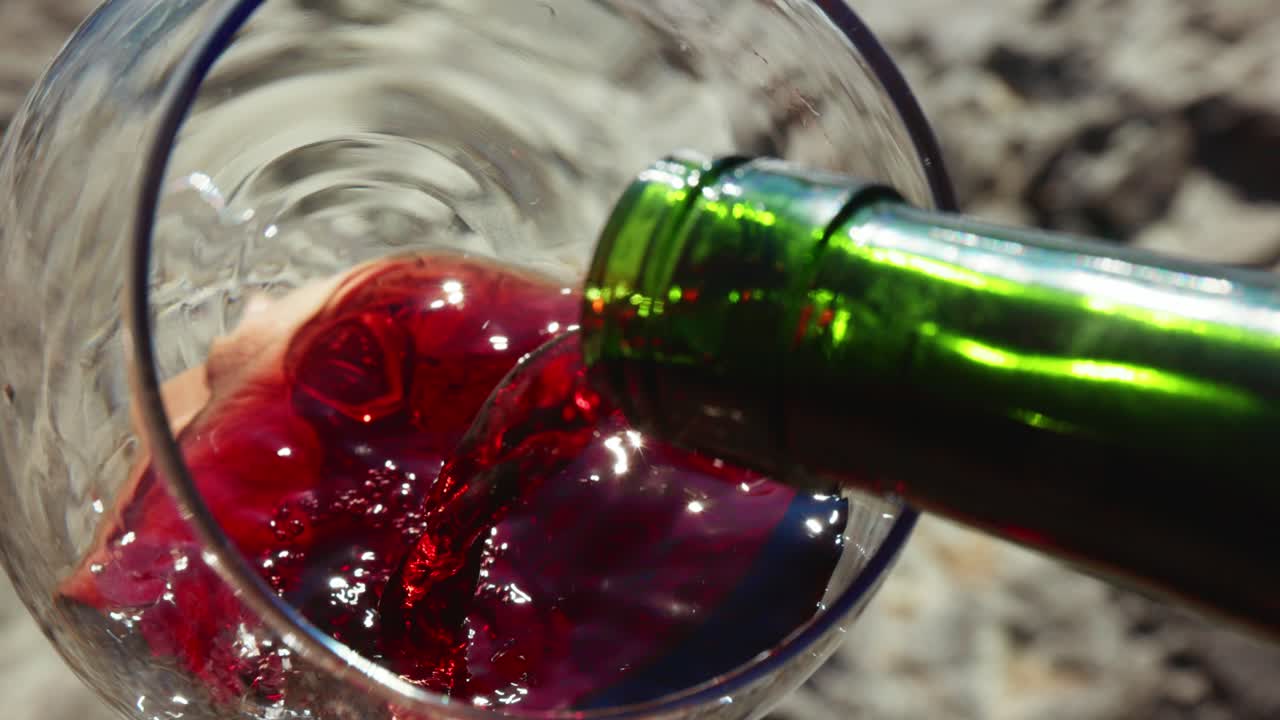 Versare il vino rosso in un bicchiere