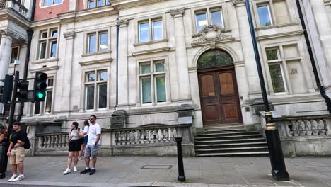 people walking near historic building in london