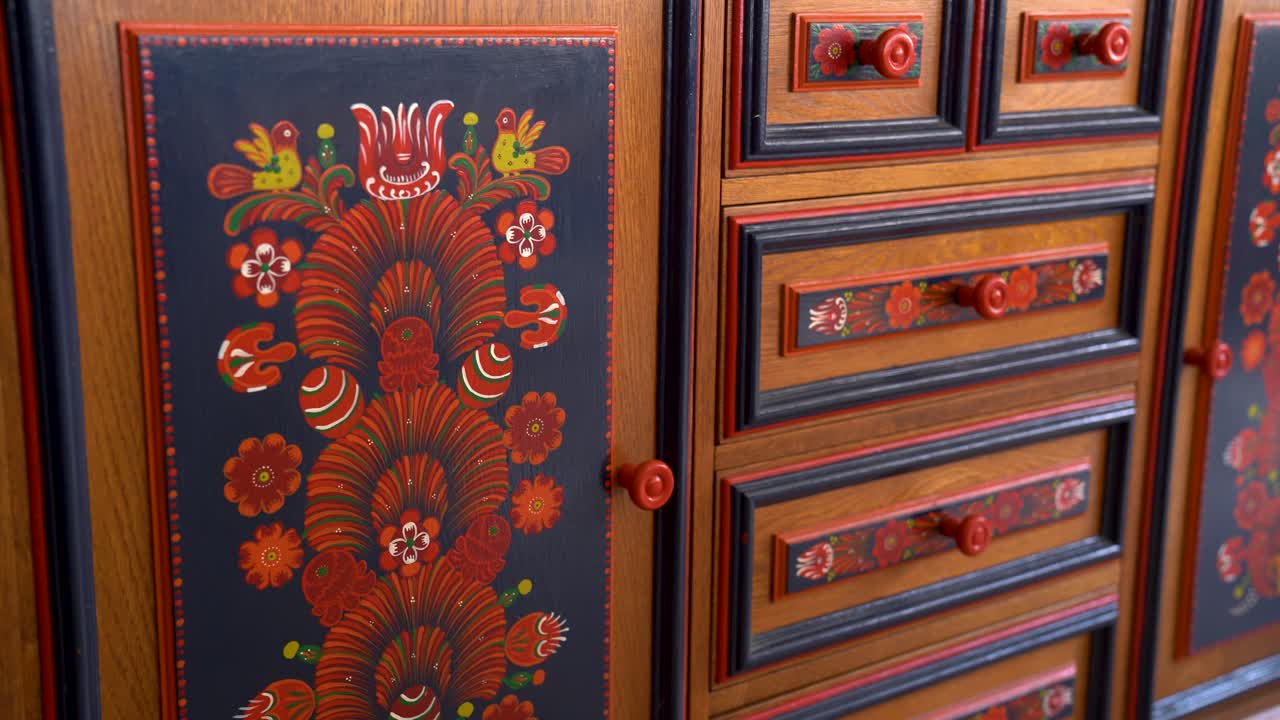 Traditional Matyó floral decoration on cabinet doors with vivid red flowers