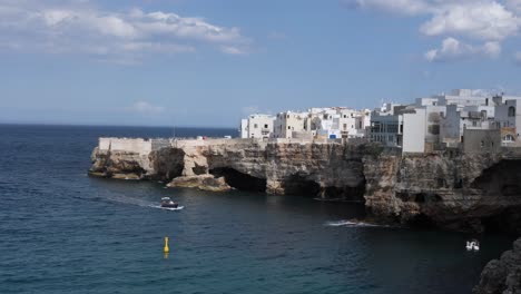 tourist boat tour drive near rocky picturesque coast of polignano a mare