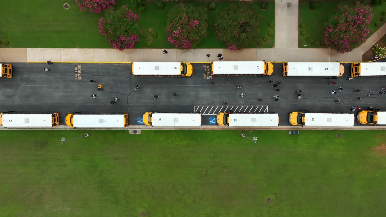 Top down aerial of row of school bus