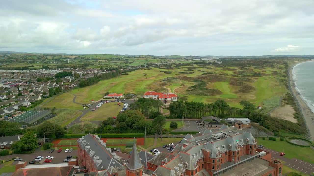 4K, 60FPS aerial video of the Slieve Donard Hotel in Newcastle, County Down in Northern Ireland. The camera travels forward from a wide shot