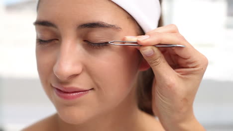 hand applying eyeshadow to a beautiful woman