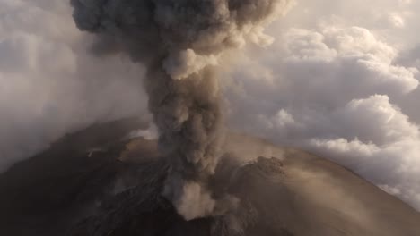 volcano explosion ash cloud rising from crater in mushroom shape, aerial