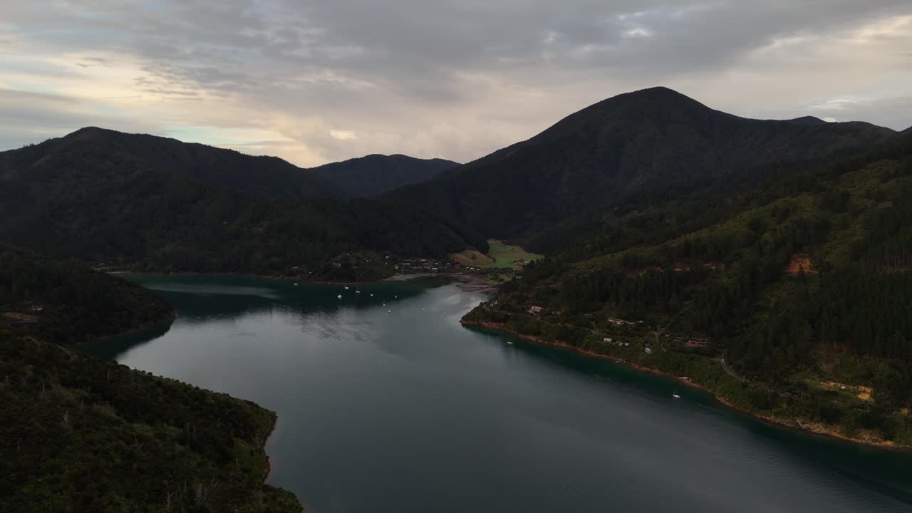 This high-quality 4K drone footage provides a sweeping panoramic view of Picton Port, showcasing the bustling harbor, ferries, and ships in New Zealand's picturesque South Island