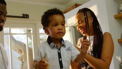 Front-view-of-young-black-family-having-fun-in-kitchen-of-comfortable-home-4k