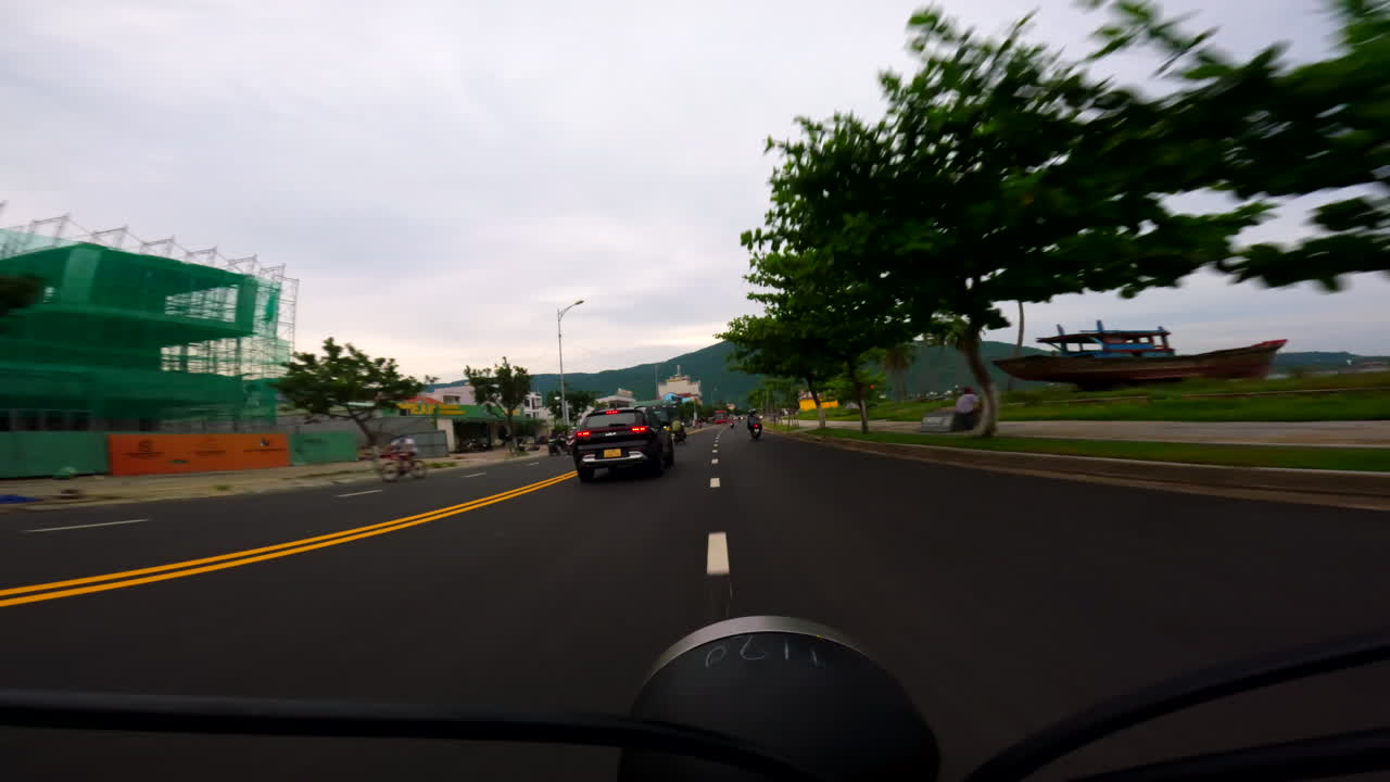 Riding through streets on a scooter, POV showing traffic, buildings, and city life from handlebars