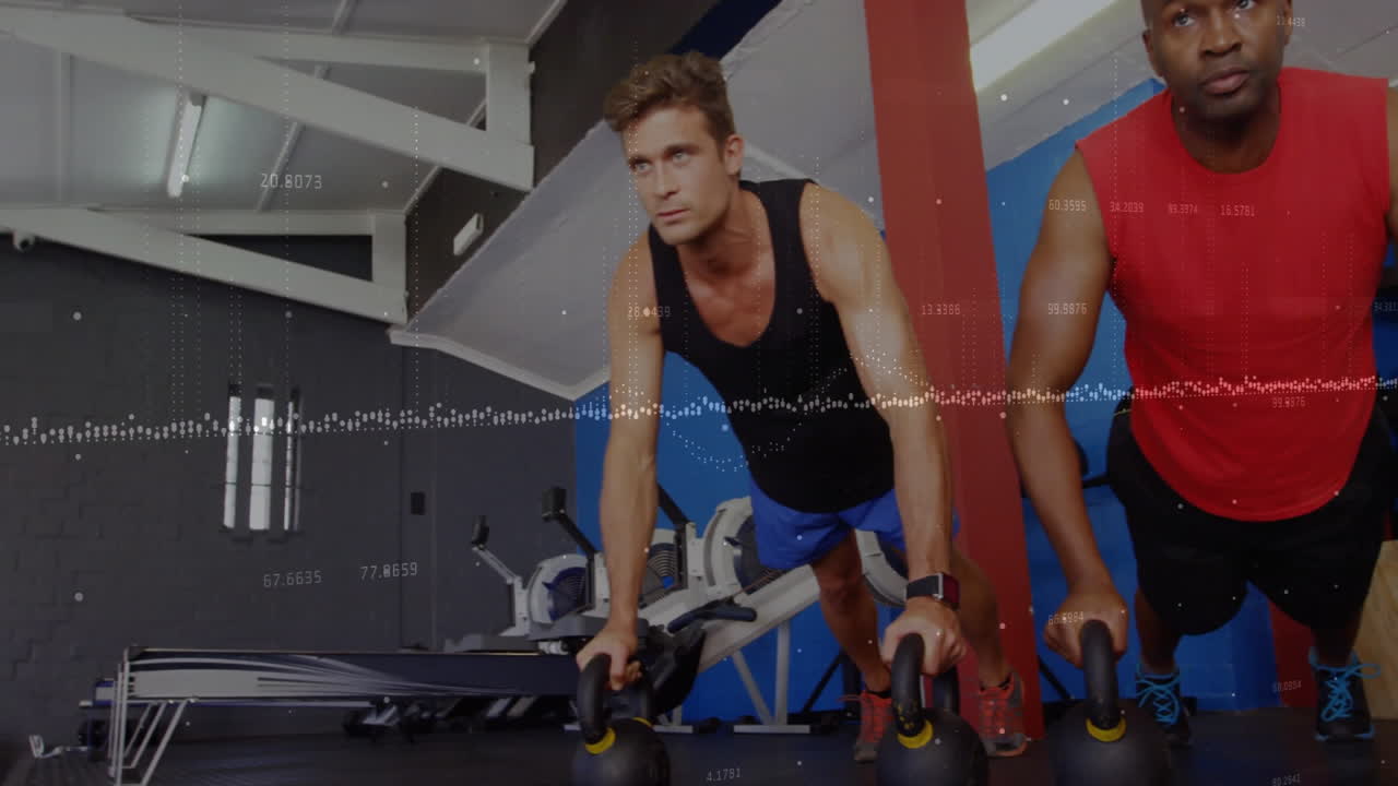 Workout partners holding kettlebell plank in fitness center, displaying floating strength graph