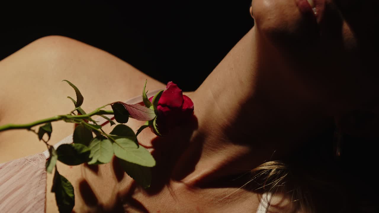 Close-up of a Red Rose on a Woman's Shoulder
