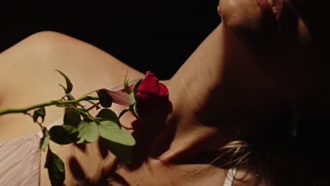 close-up of a red rose on a woman's shoulder