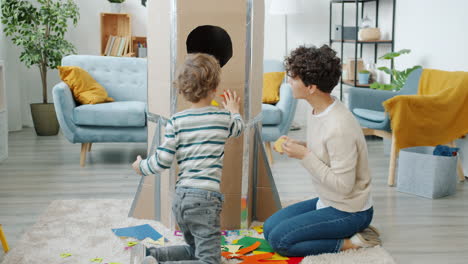 mother and child making a cardboard rocket