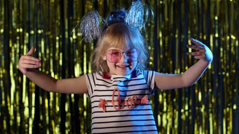 portrait of trendy stylish girl showing magic tricks gestures, fooling around at disco night club