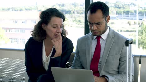 focused business colleagues using laptop