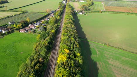 dolly forward towards a countryside train station with beautiful coloured trees