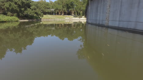 a low shot of a river by a quiet san antonio neighborhood