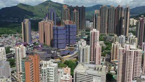 aerial flyover dense high rise residential buildings in yuen long, hong kong