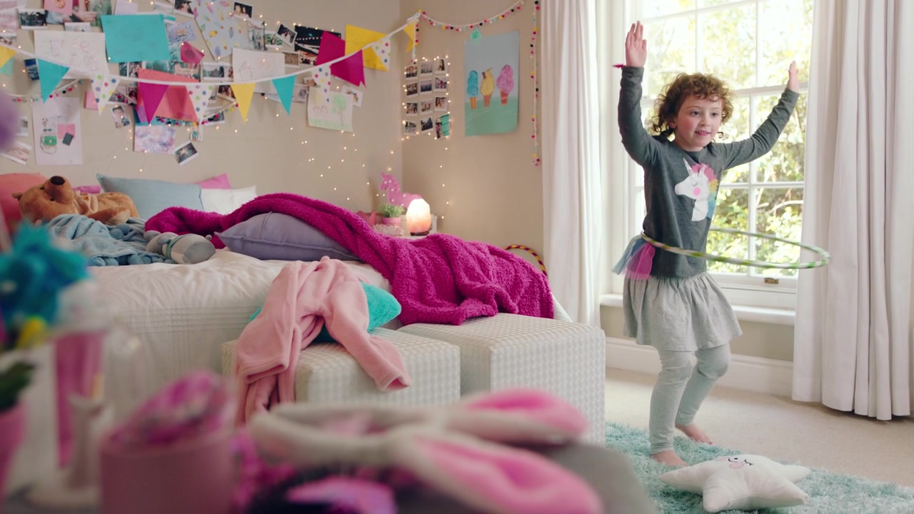 Little Girl Playing with Hula Hoop in Her Bedroom