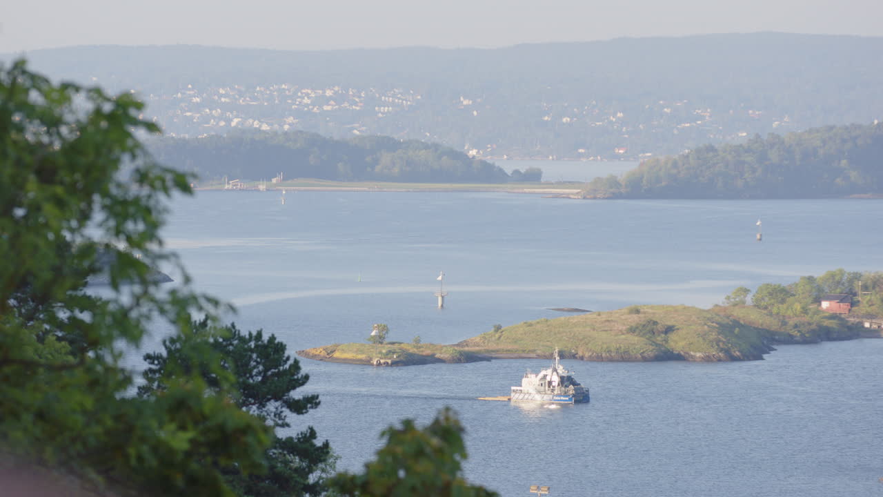 High view from Ekebergparken of vessel cruising on Oslofjord between islands