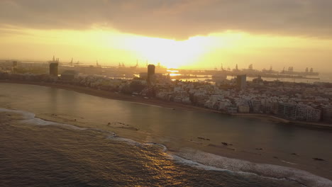 panoramic aerial shot of las canteras beach at dawn and where the buildings on the beach can be seen