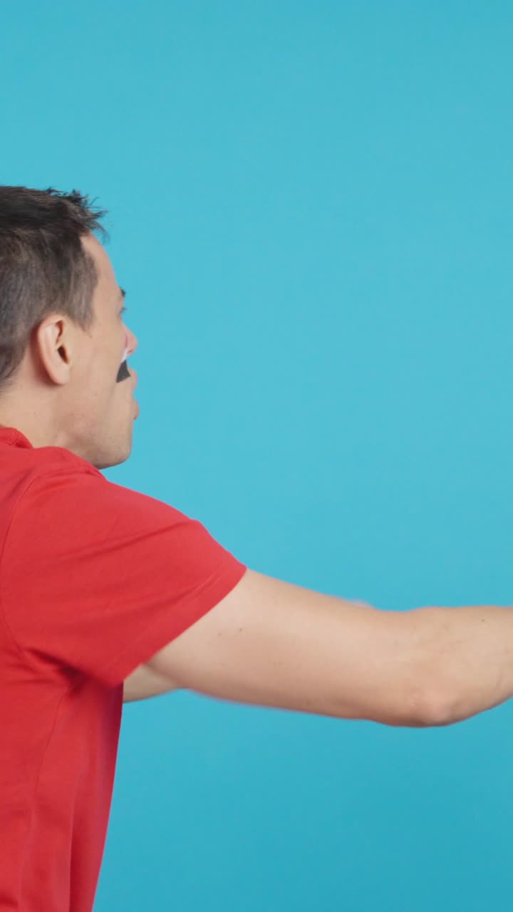 Rear view of a man waving a egyptian pennant