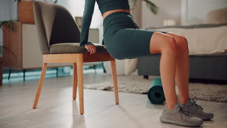 woman doing chair dips for triceps exercise at home