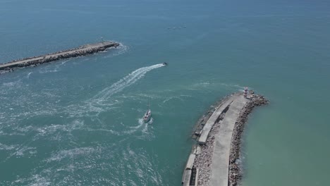 Two-boats-departing-from-the-deserted-beach-shore-at-praia-deserta