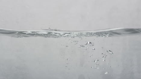 video of beauty product tub falling into water with copy space on white background