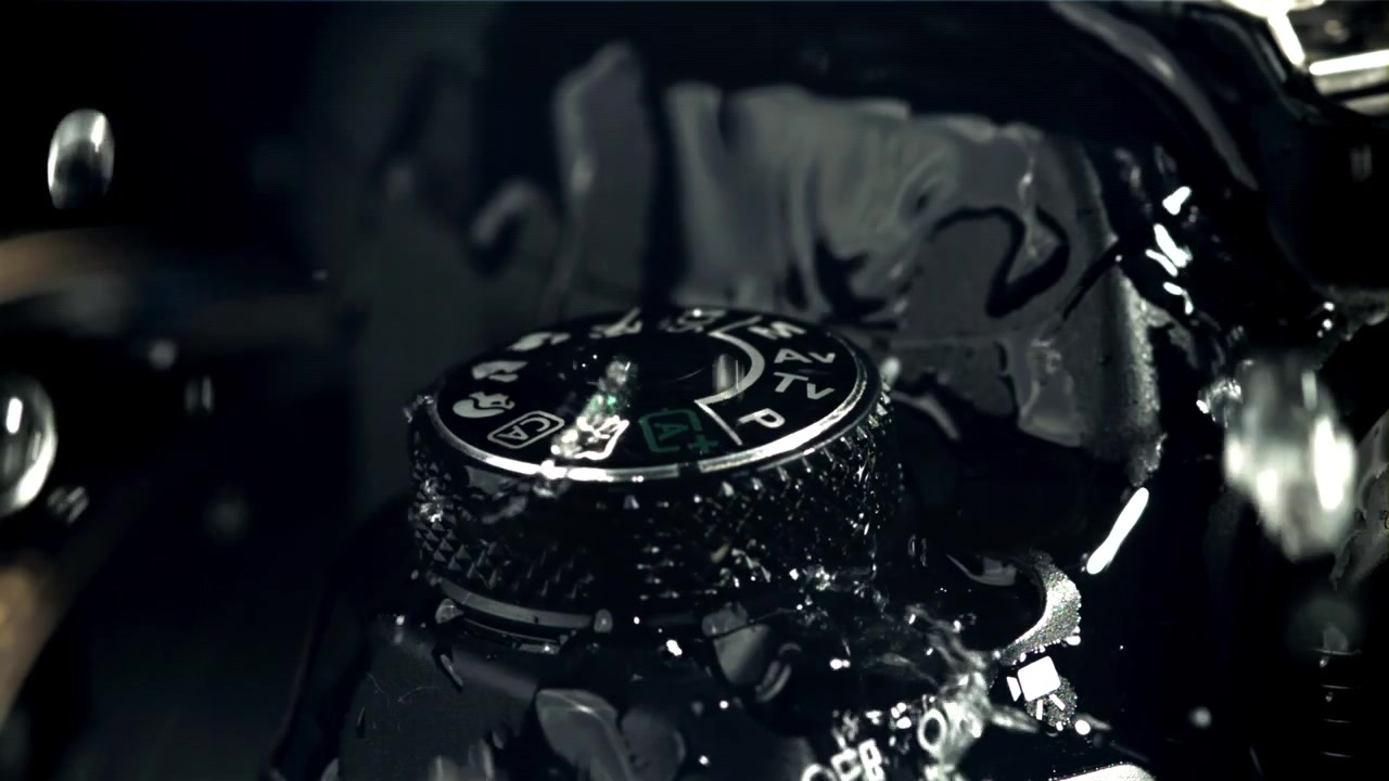 Slow Motion Water Splashing on a DSLR Camera Mode Dial