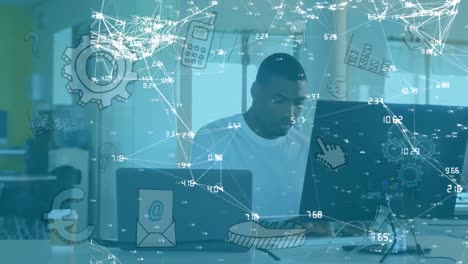 animation of network of connections and media icons over businessman at desk using computer
