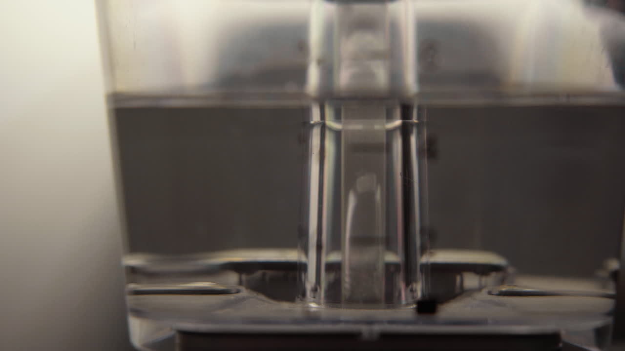 Water running through water tank of a coffee machine moccamaster close up 4k