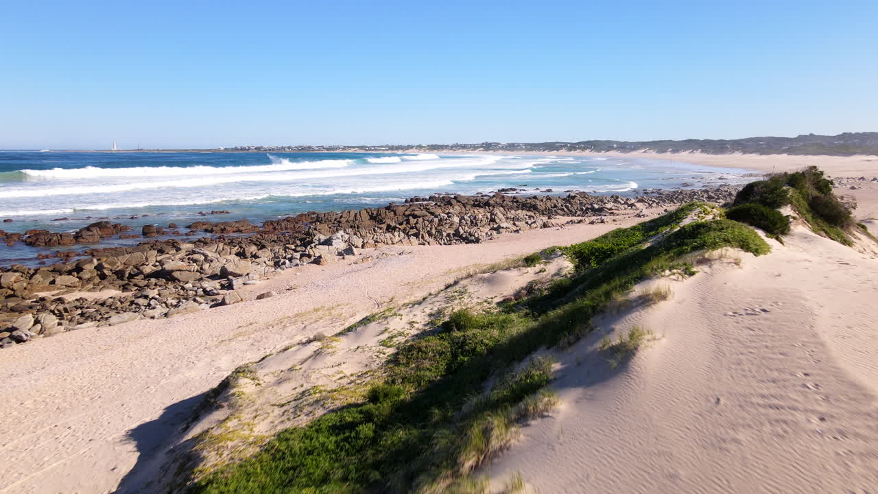 Low aerial over coastal dunes of Cape St Francis nature reserve with fynbos