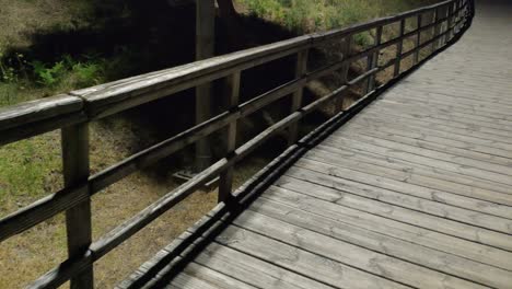 overpass with its wooden safety gate with lighting of street lamps at night in the garden area