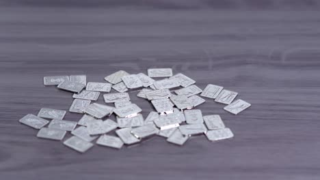 fine silver one gram bars laying on a table - 4k