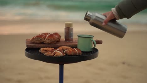 breakfast on the beach with delicious sweet breads and coffee, luxury picnic lifestyle during relaxing vacations