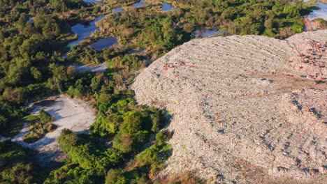 view from drone – environmental damage of city landfill nearby nature areas