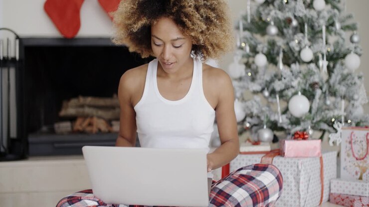 Pretty young student in front of a Christmas tree