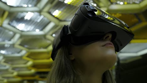 woman wearing vr headset in a modern building