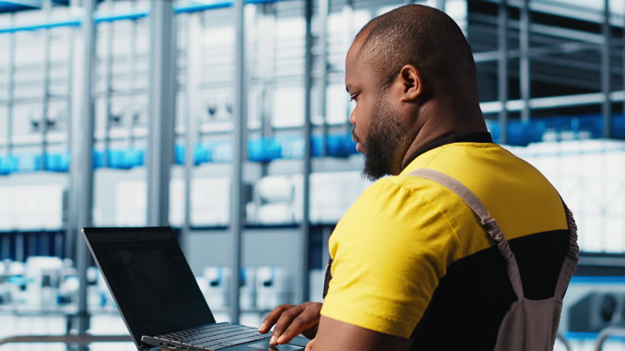 Photovoltaics smart factory technician fixing damaged IoT sensors using laptop