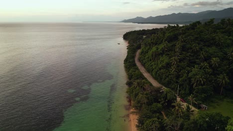 Mamangal-beach-with-lush-greenery-in-virac,-catanduanes-at-sunset,-aerial-view