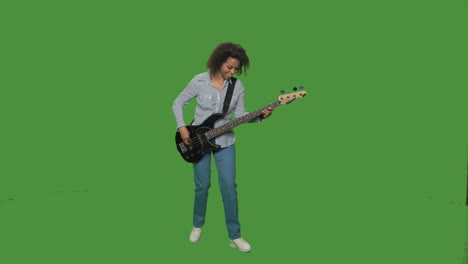 woman playing bass guitar on green screen