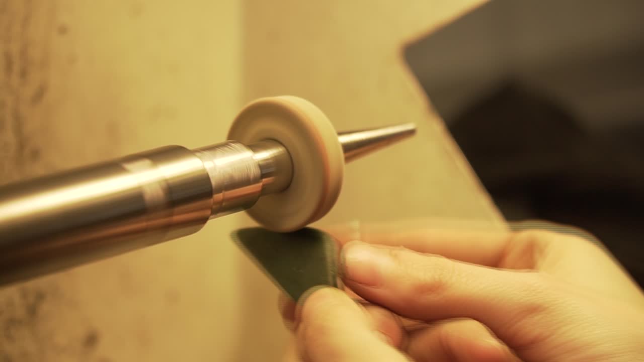 천으로 디스크 광택기를 청소하고 녹색 돌을 연마