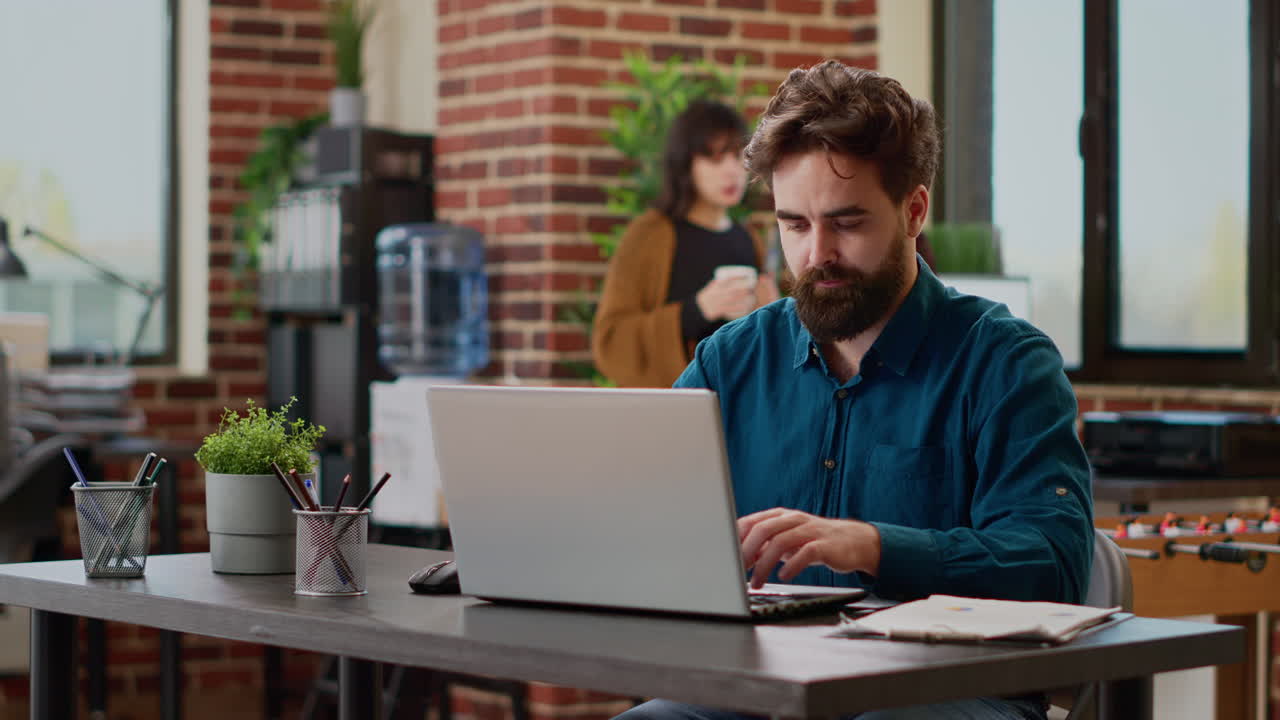 Portrait of business man working on laptop with charts and graphs