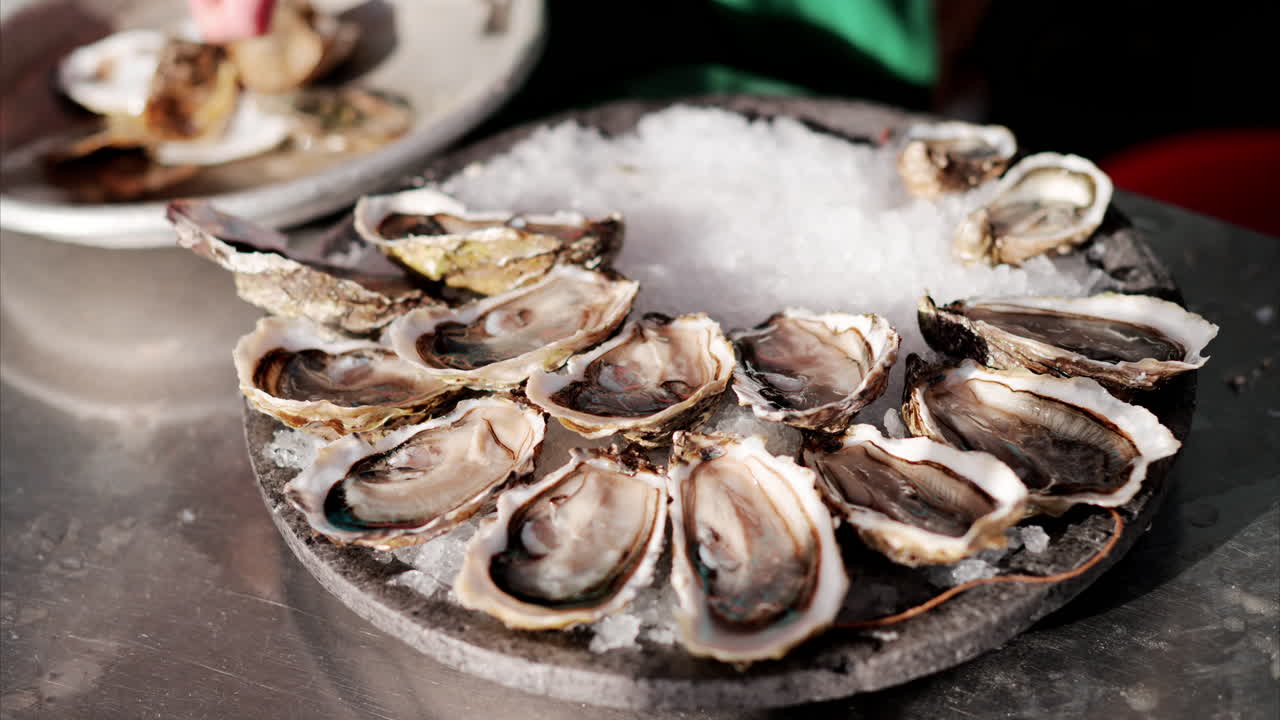 Close up of a plate with raw oyster on ice at a restaurant