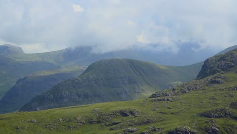 Thick-cloud-moving-very-rapidly-over-mountainous-landscape-as-cloud-shadows-move-over-mountainsides