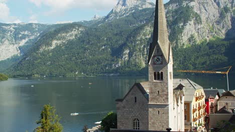 Majestic-scenery-of-Hallstatt-town-with-view-of-famous-church-and-lake,-summer