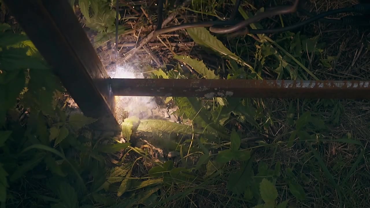 slow motion welder fixes bottom rail to fence carcass