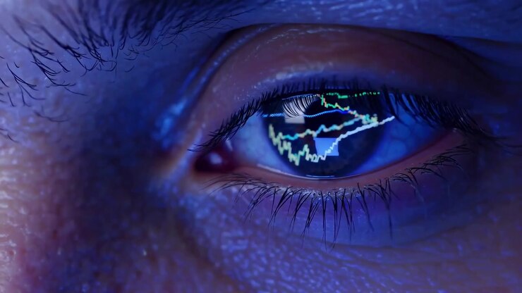 Extreme Close-up of Human Eye Reflecting Financial Stock Market Charts