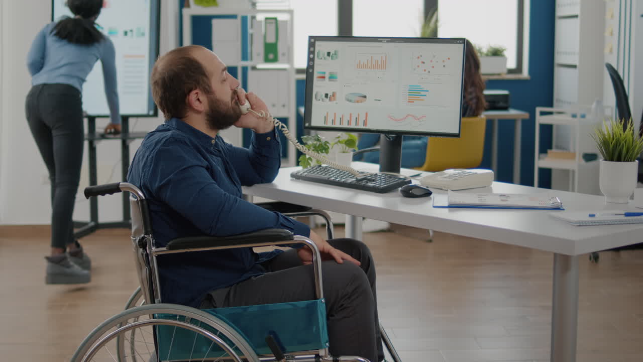 Entrepreneur with locomotor disabilities talking at phone